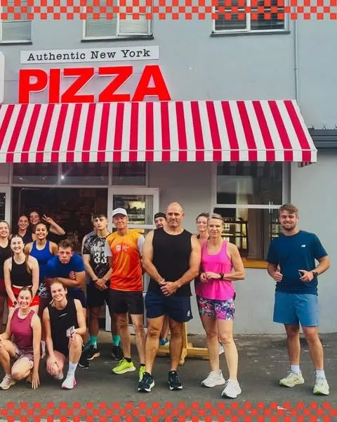 The run club outside an NY Slice store